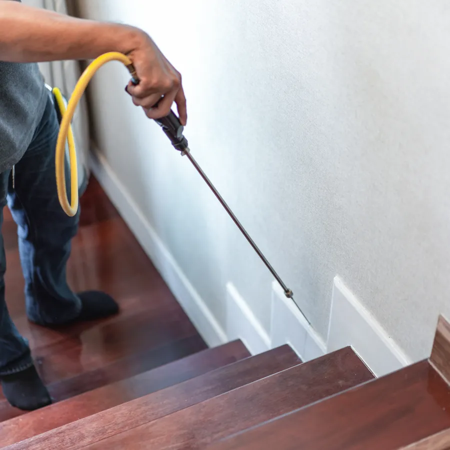 a man holding a yellow hose