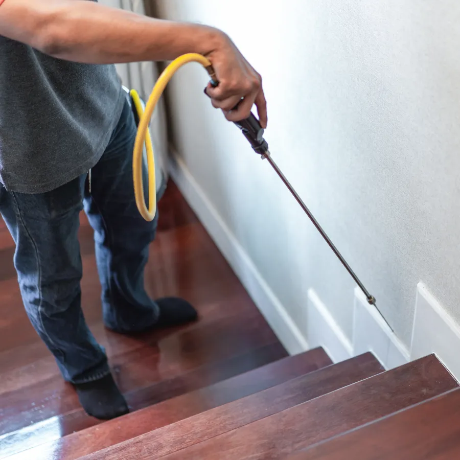 a man holding a yellow hose