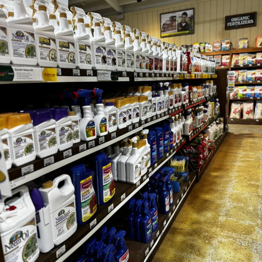 Aisle of organic fertilizers and plant care products neatly arranged on wooden shelves in a garden store