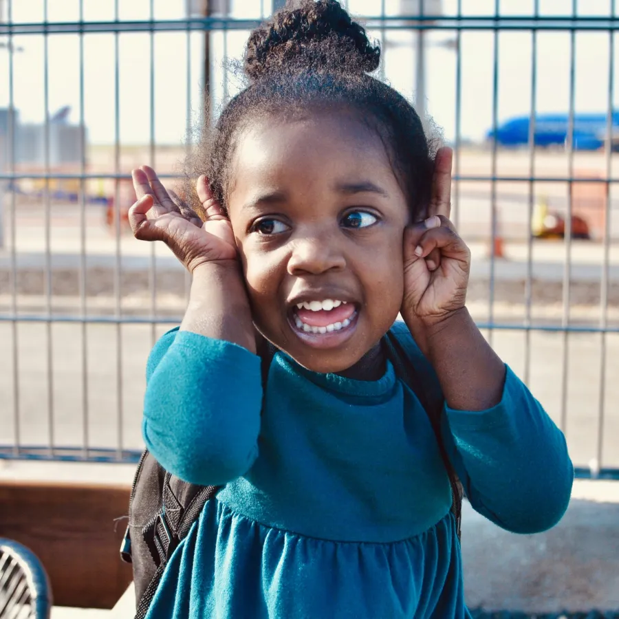 a girl with her hands on her head