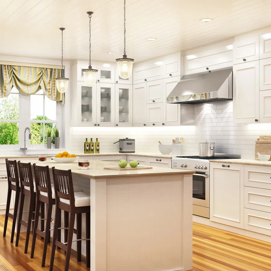 Bright modern kitchen with white cabinets, hardwood floors, island with stools, and large window with curtains.
