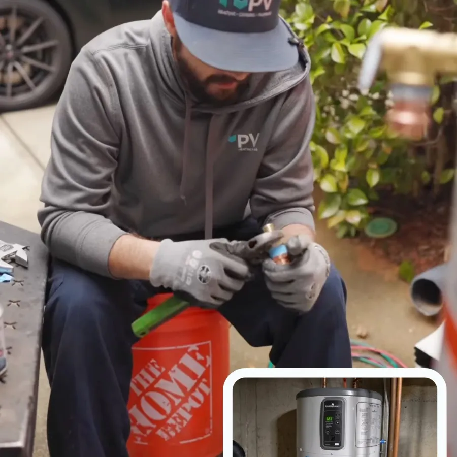 Technician installing a heat pump water heater in a residential setting.