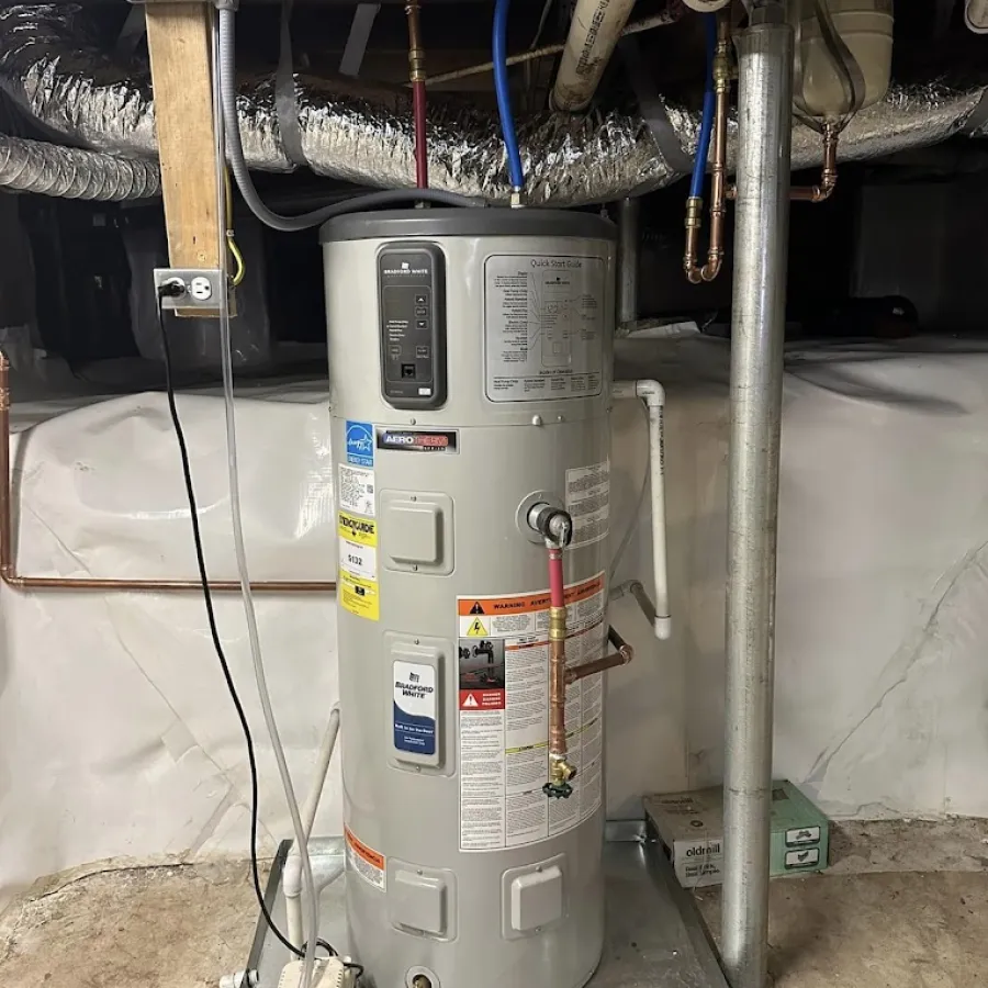 Modern water heater installed in a basement with visible plumbing and insulation features.
