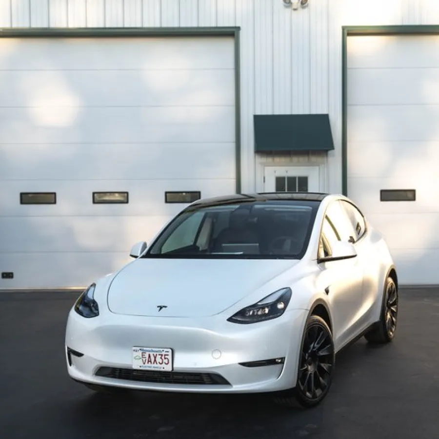 a white car parked in front of a garage