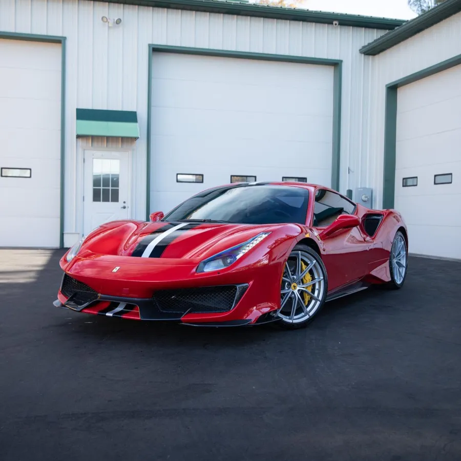 a red sports car parked in front of a garage