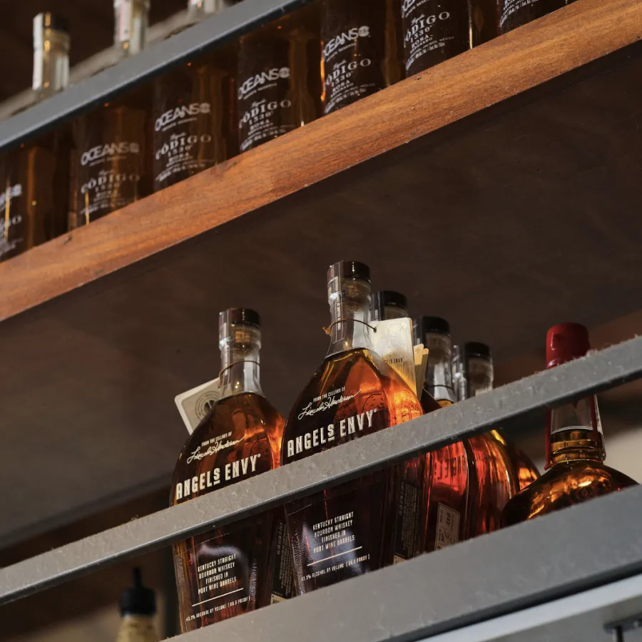 a shelf with bottles of alcohol on it