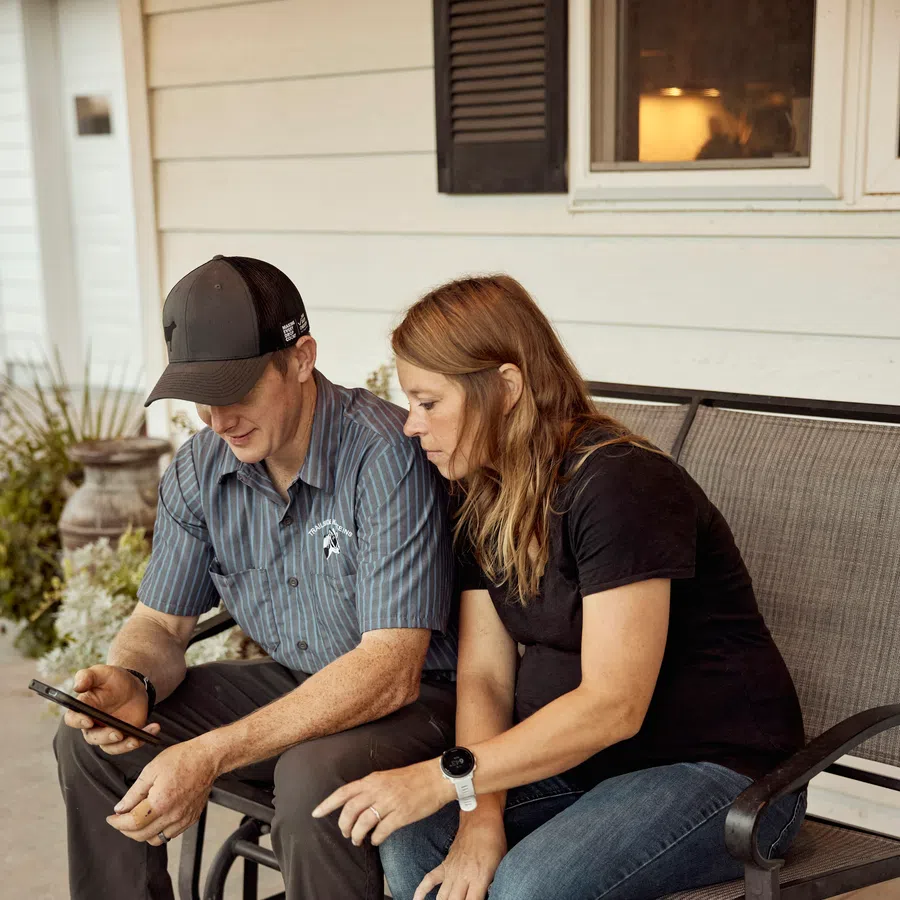 Service technician reviewing details with a homeowner on her front porch