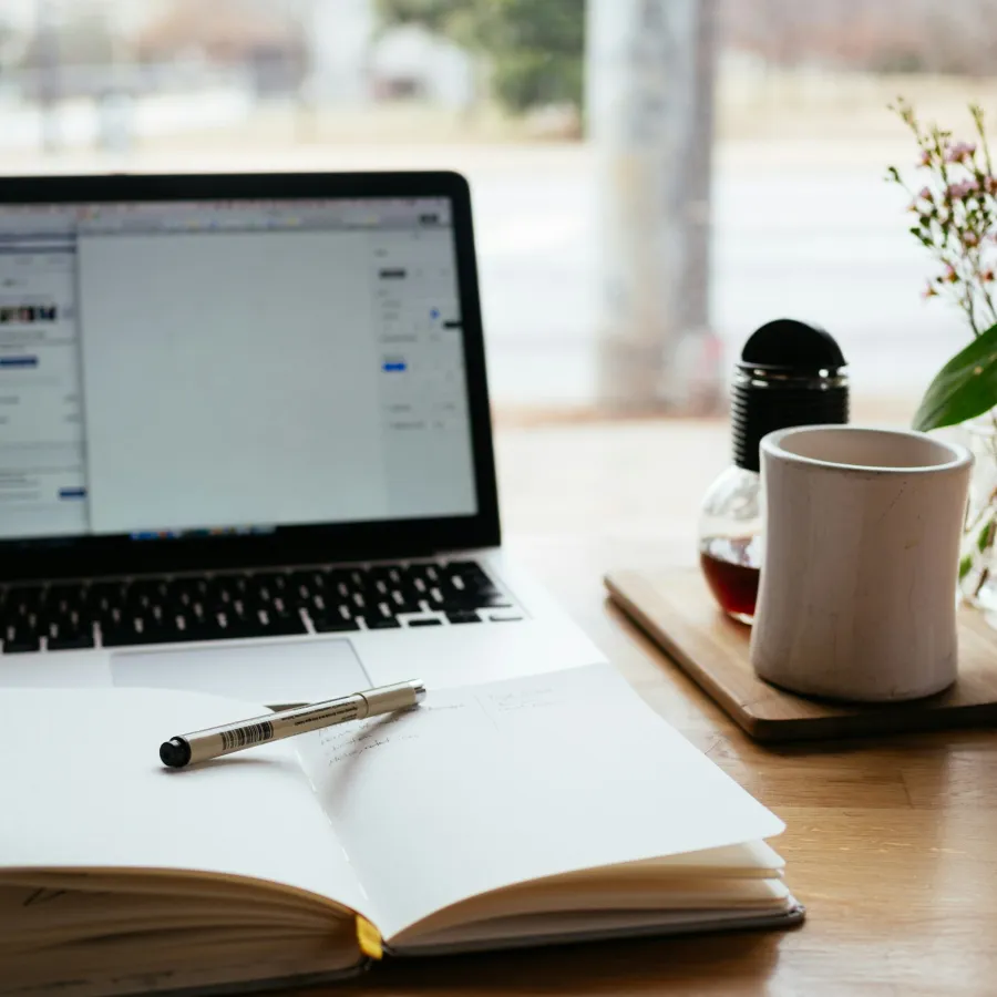 a laptop and a pen on a table