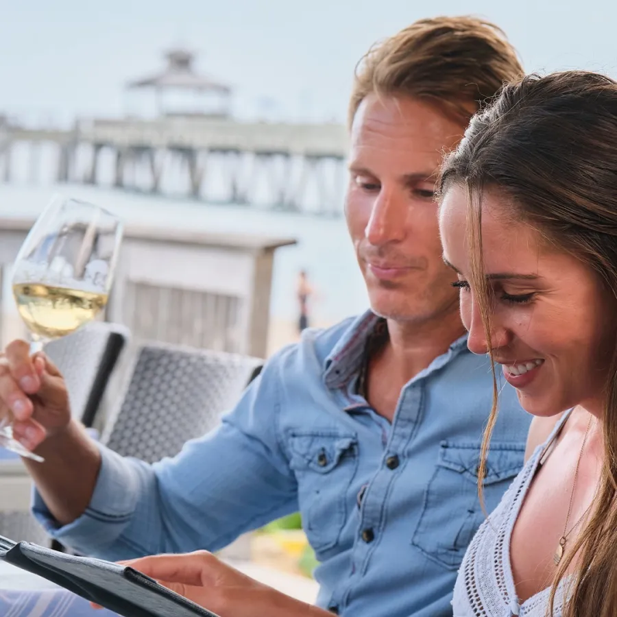 a man and a woman looking at a tablet