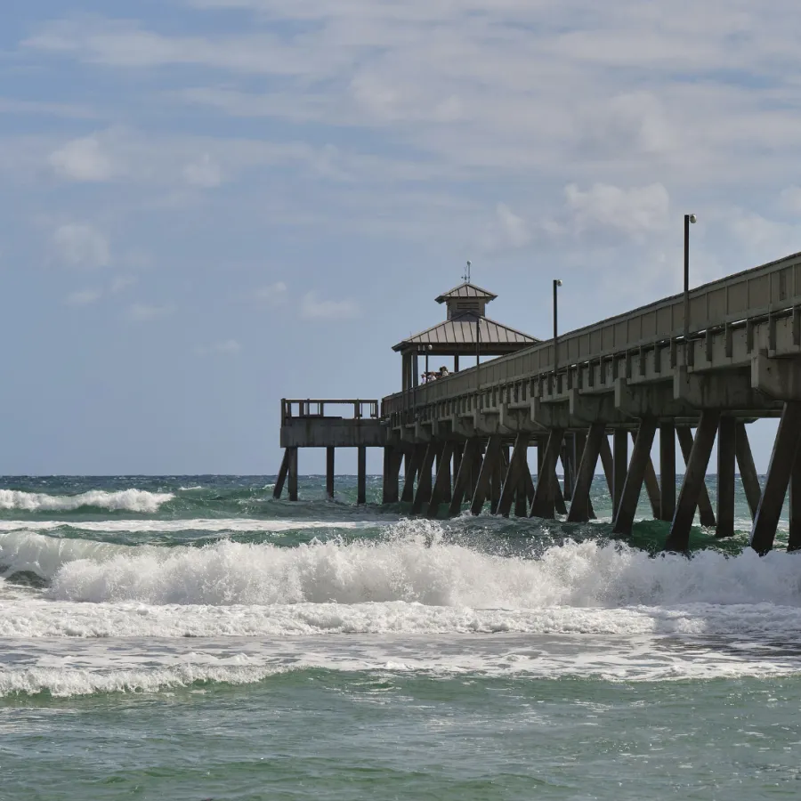 a pier with waves crashing against it