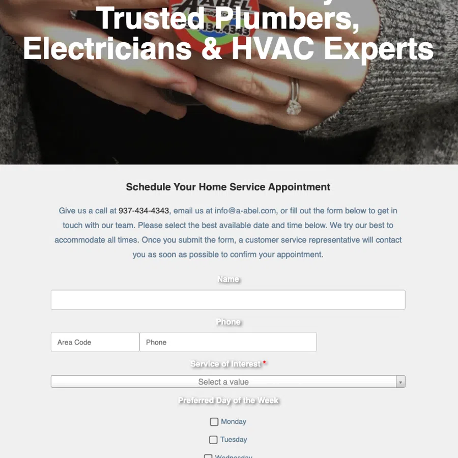 Hands holding a phone with A-Abel company logo and text promoting plumbers, electricians, and HVAC experts.