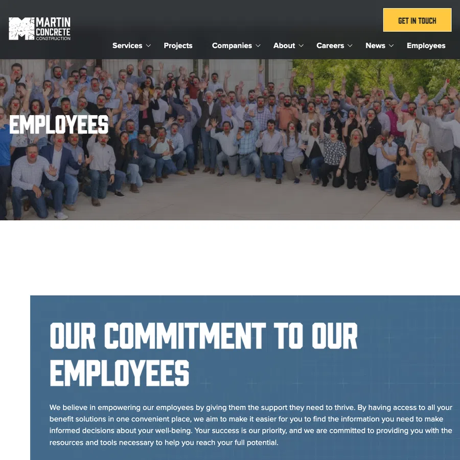 Large group of employees wearing red clown noses posing outdoors in front of Martin Concrete Construction banner.