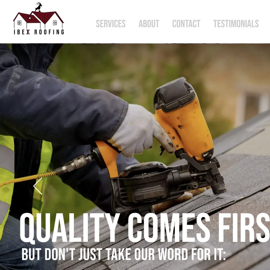 Close-up of worker using nail gun to install roofing shingles on house roof outdoors