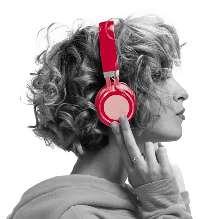 Side profile of a person with curly hair wearing bright red headphones and a light hoodie.