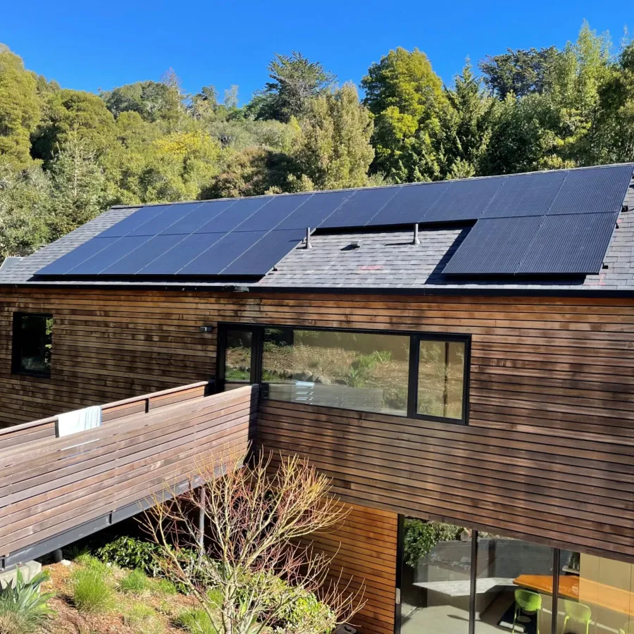 a house with a deck and trees in the back