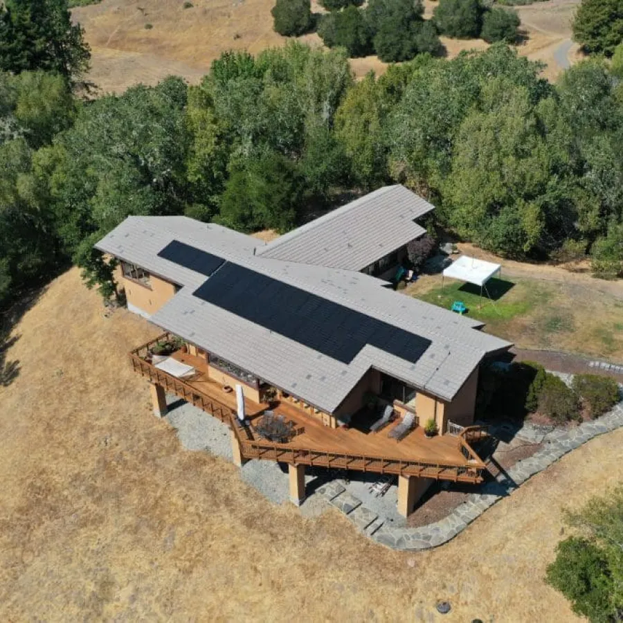 a house with a roof surrounded by trees