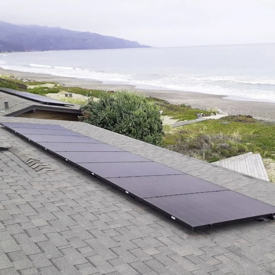 a roof with a solar panel on it by a beach