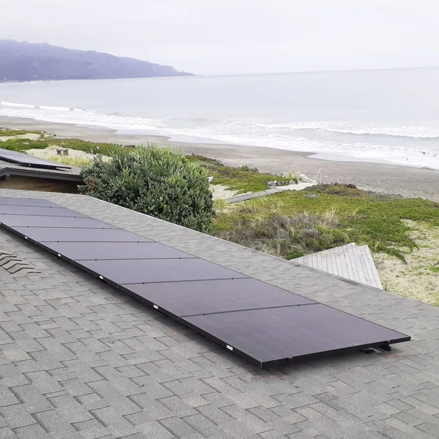 a roof with solar panels on it by a beach