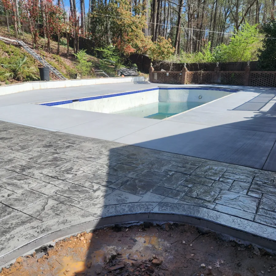 Traditional pool deck with decorative stamped concrete extension