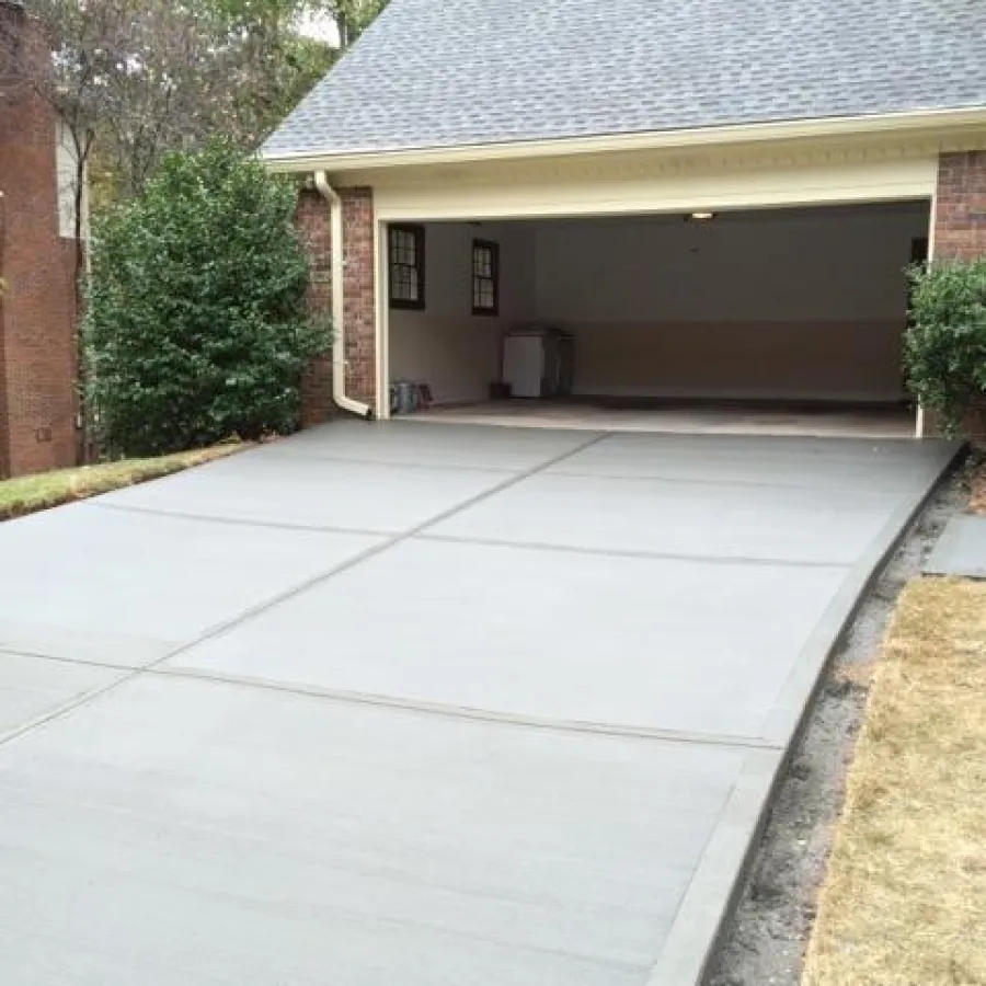 a driveway with a garage and a house