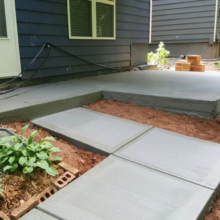 a small backyard with a small patio