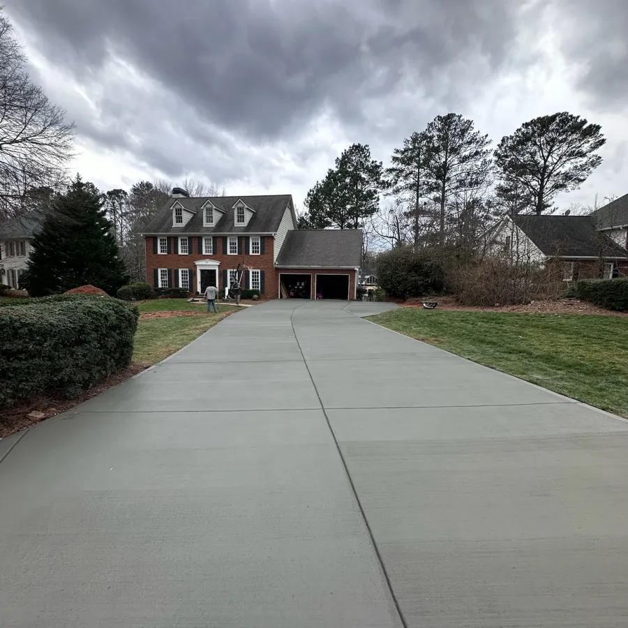 a sidewalk with a driveway and houses