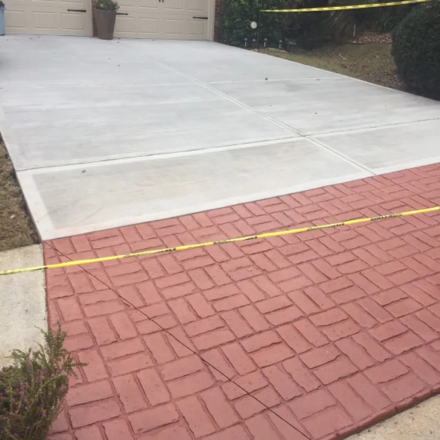 a brick driveway with a brick walkway