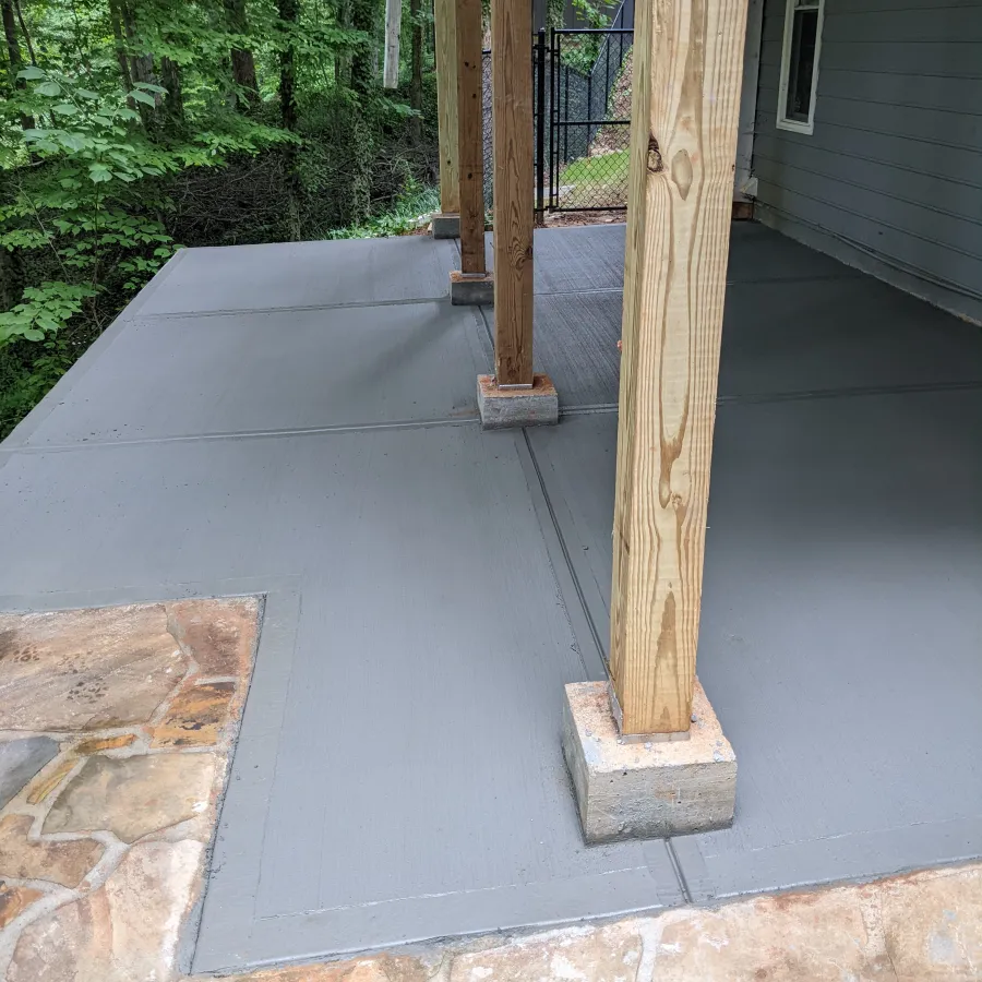 a stone patio with a wood door