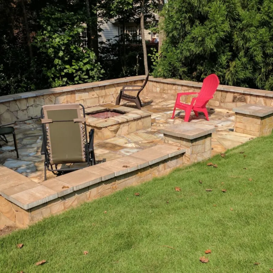 a backyard with chairs and a table