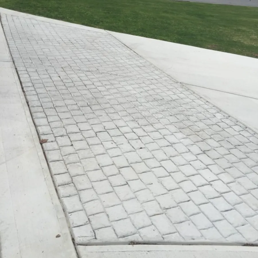 a sidewalk with a brick walkway