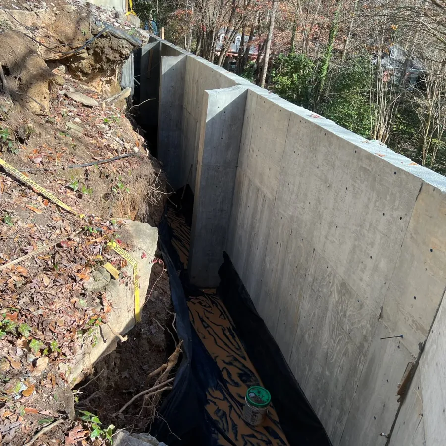 a concrete wall with a water pipe