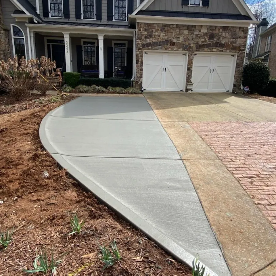 a brick driveway leading to a house