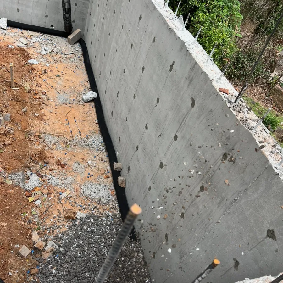 a concrete wall with a pipe