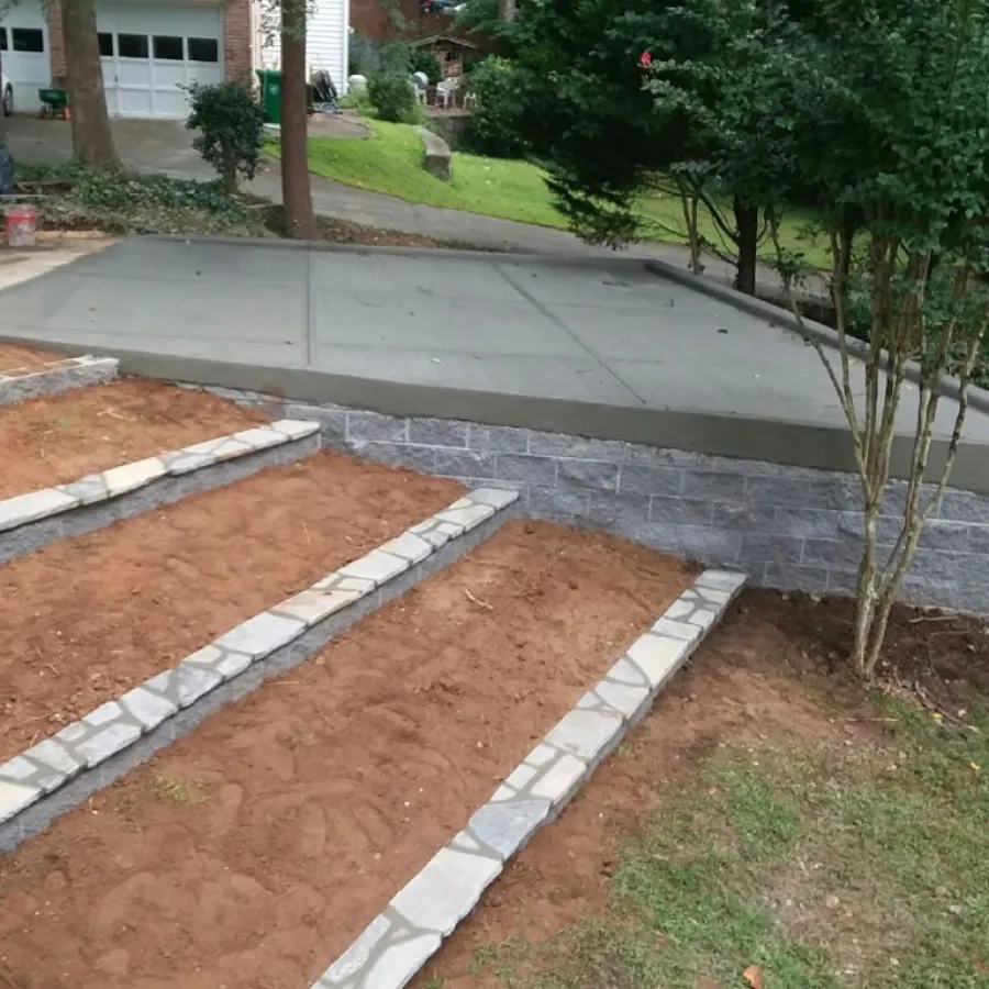 a brick walkway with a tree