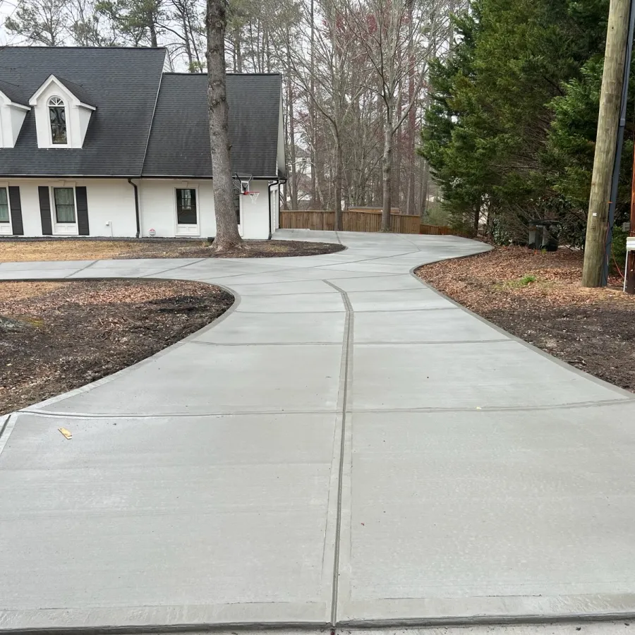 a sidewalk with trees and houses