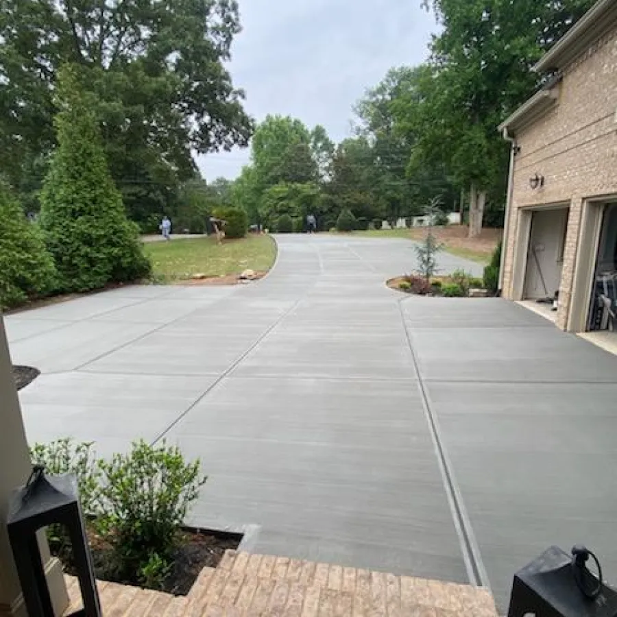 a paved area with trees and grass