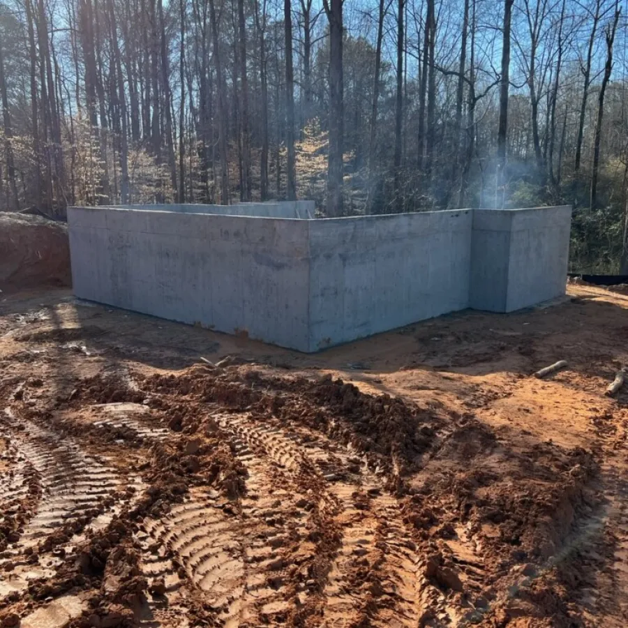 a concrete wall with trees in the background