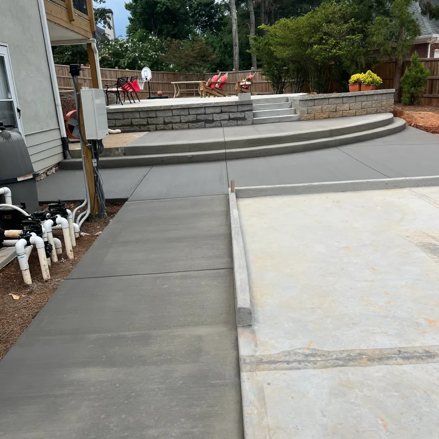 a concrete walkway with a white dog