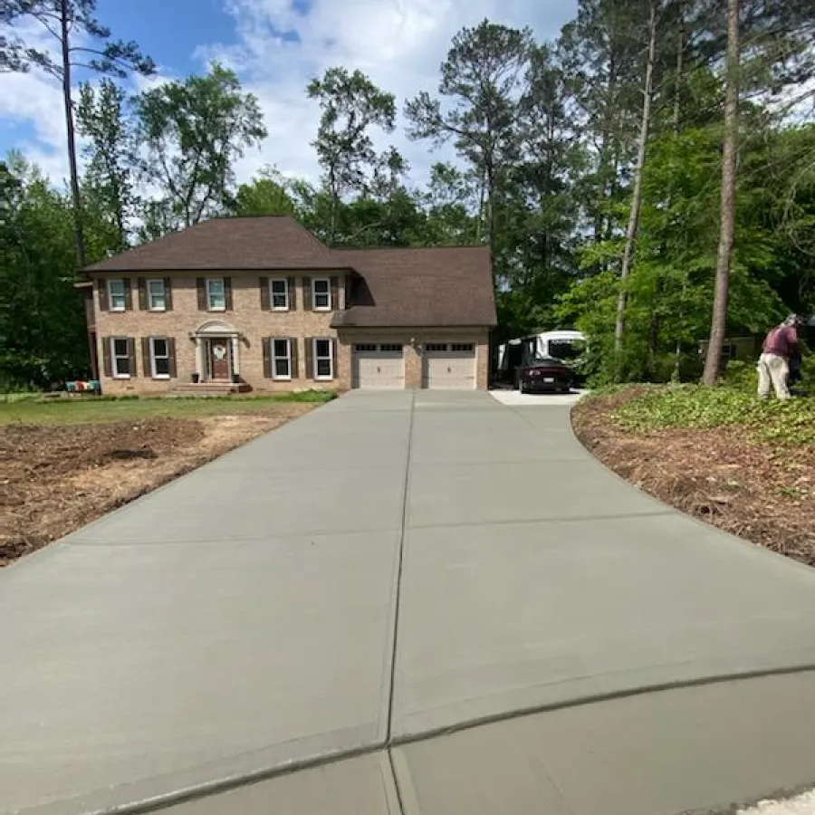 a house with a driveway and a person walking by it