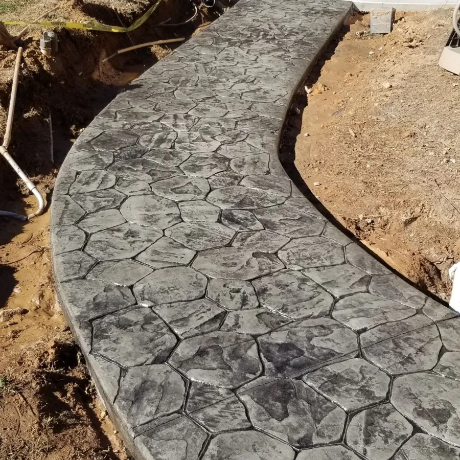 a stone walkway with a stone wall