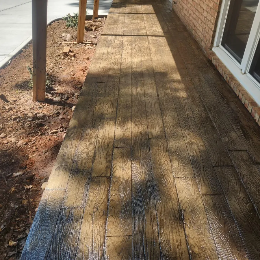 Stamped concrete with wood plank look adding classic charm to the home