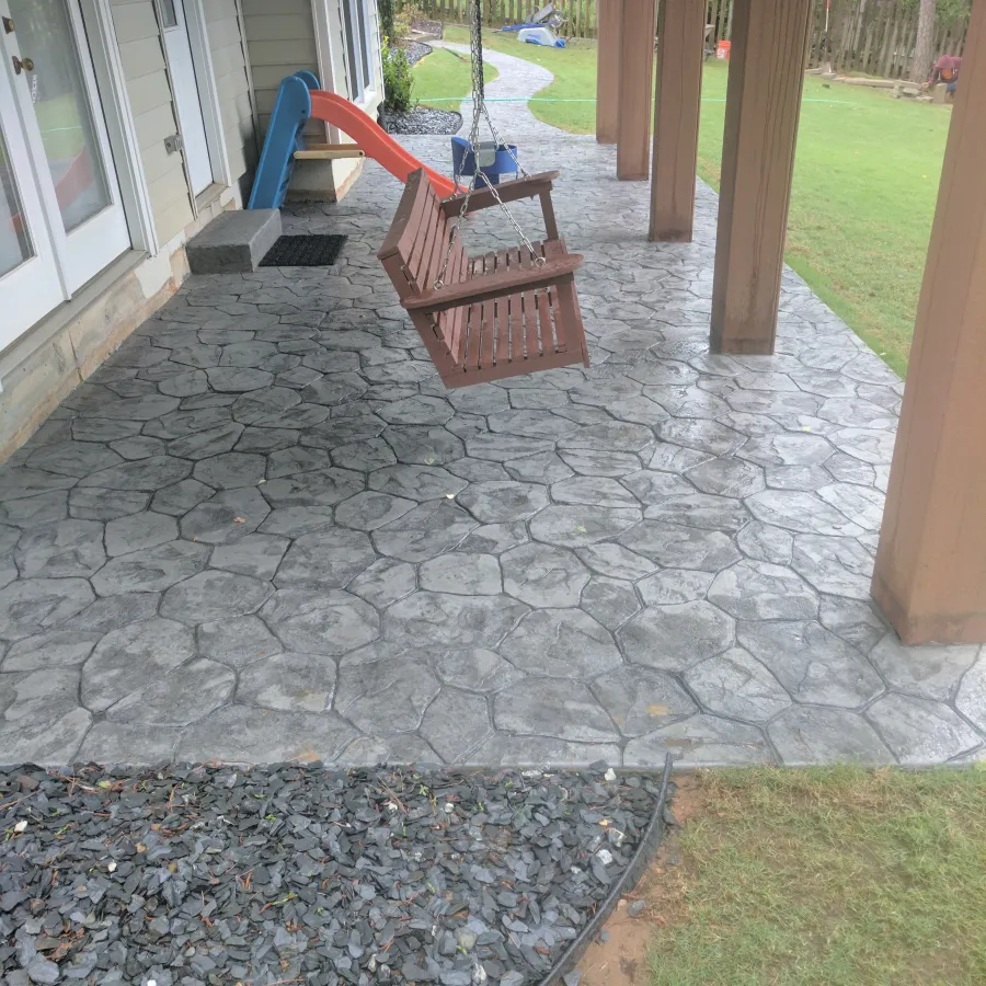 a small patio with a bench and a small pool