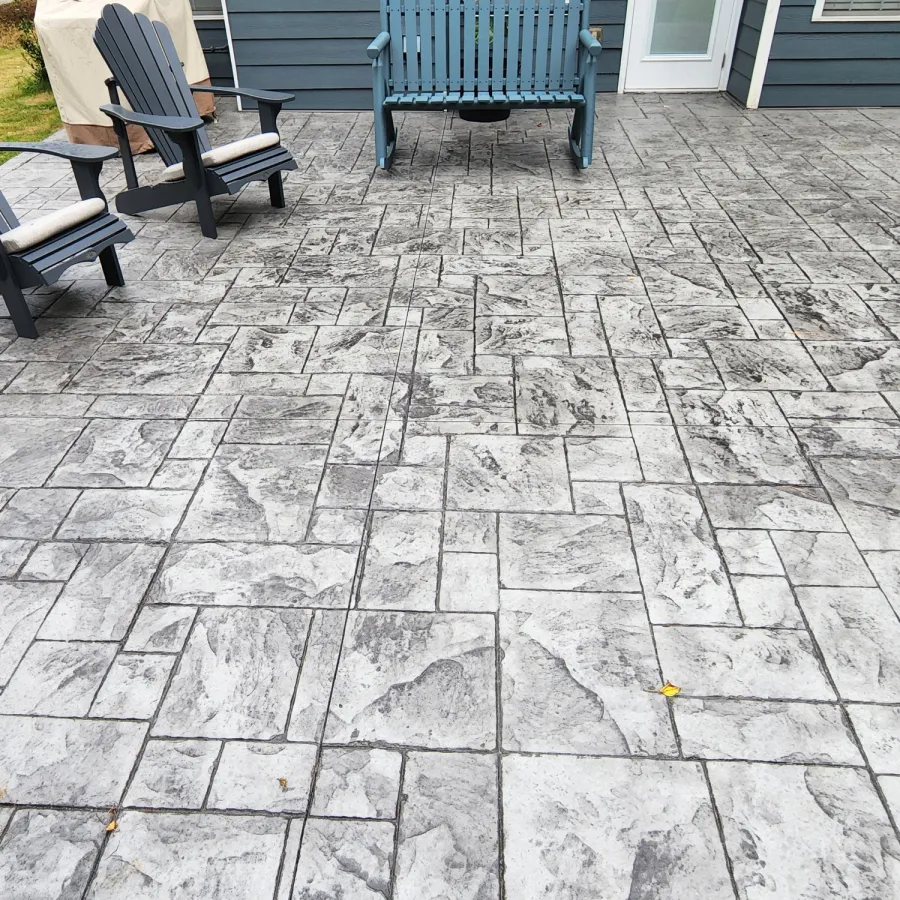 a stone patio with benches