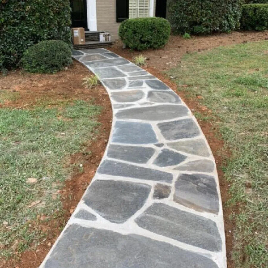 a driveway with a stone walkway