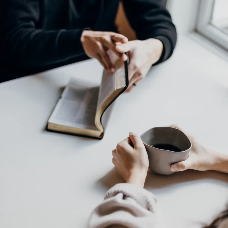 couple reading scripture at the table with coffee