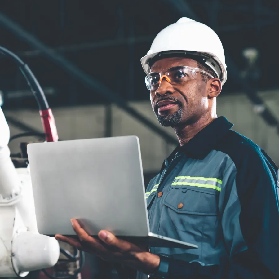 a man in a hard hat using a laptop