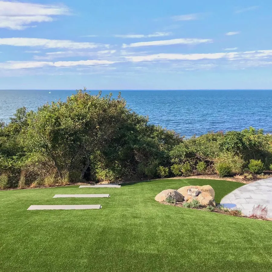 a golf course with a body of water in the background