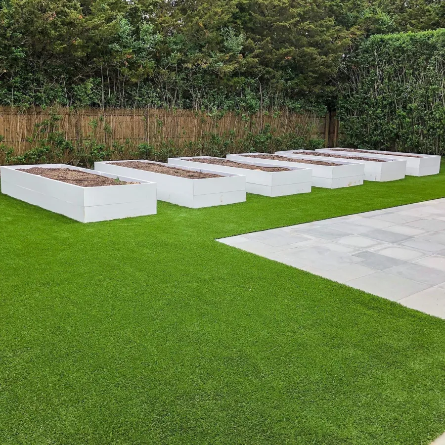 a group of white boxes on a grass lawn