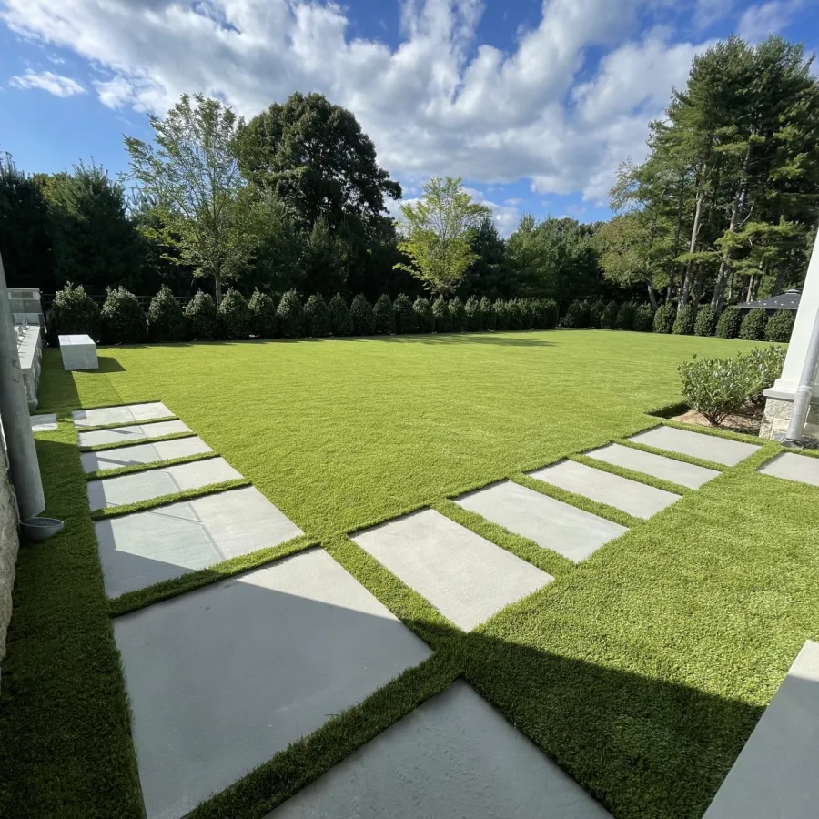 a large green lawn with white stones