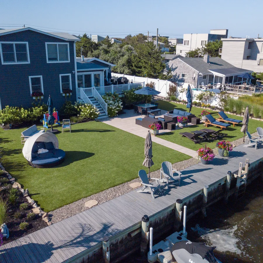 a backyard with a pool and chairs